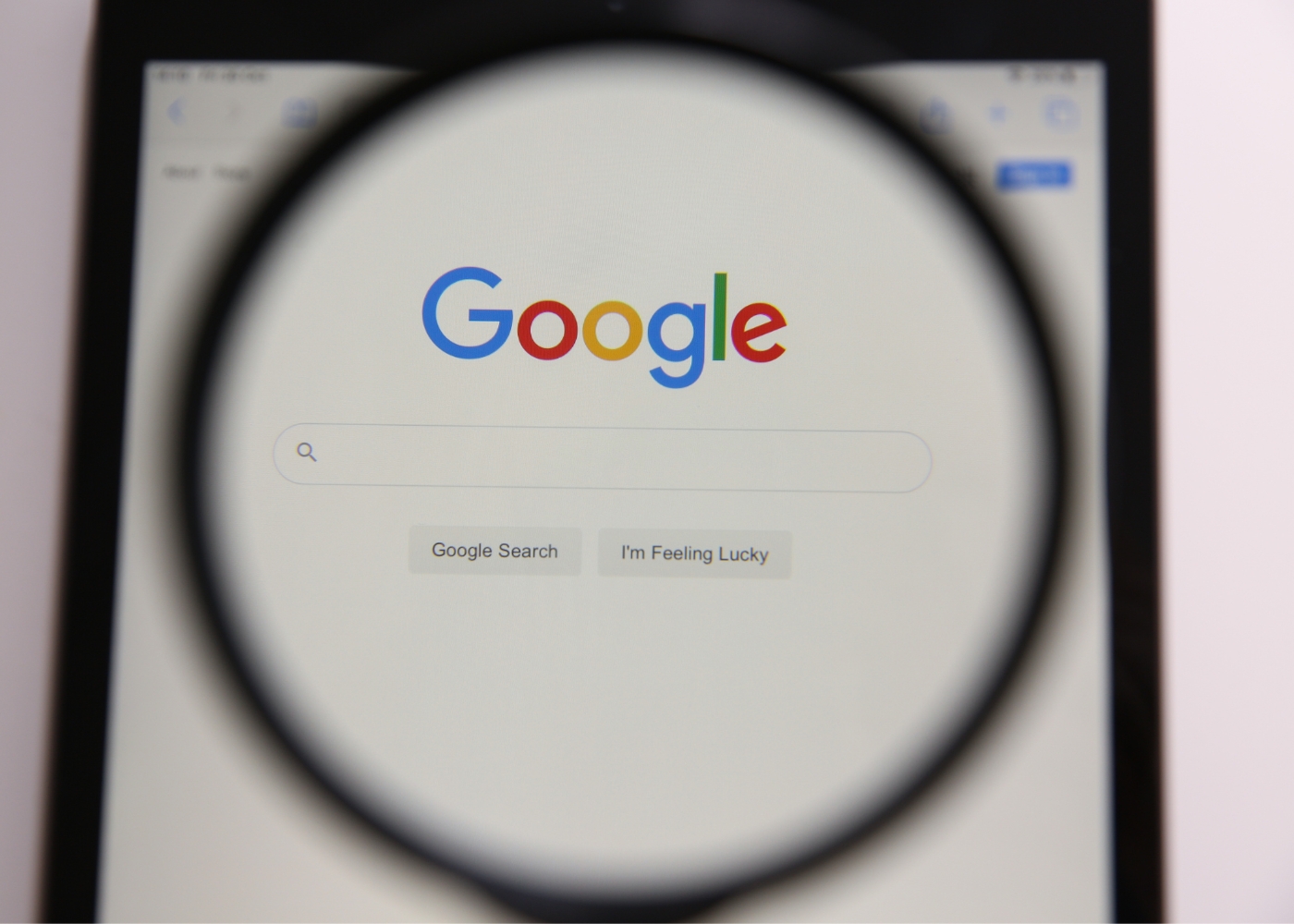 SEO or Search Engine Optimization - A magnifying glass over the google search screen.