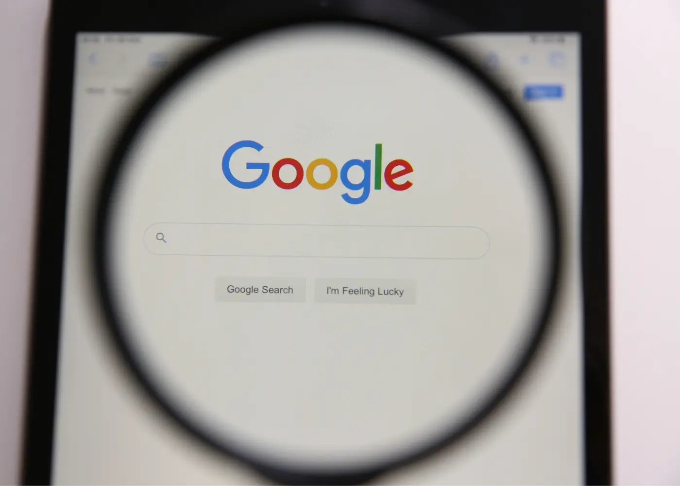 SEO or Search Engine Optimization - A magnifying glass over the google search screen.